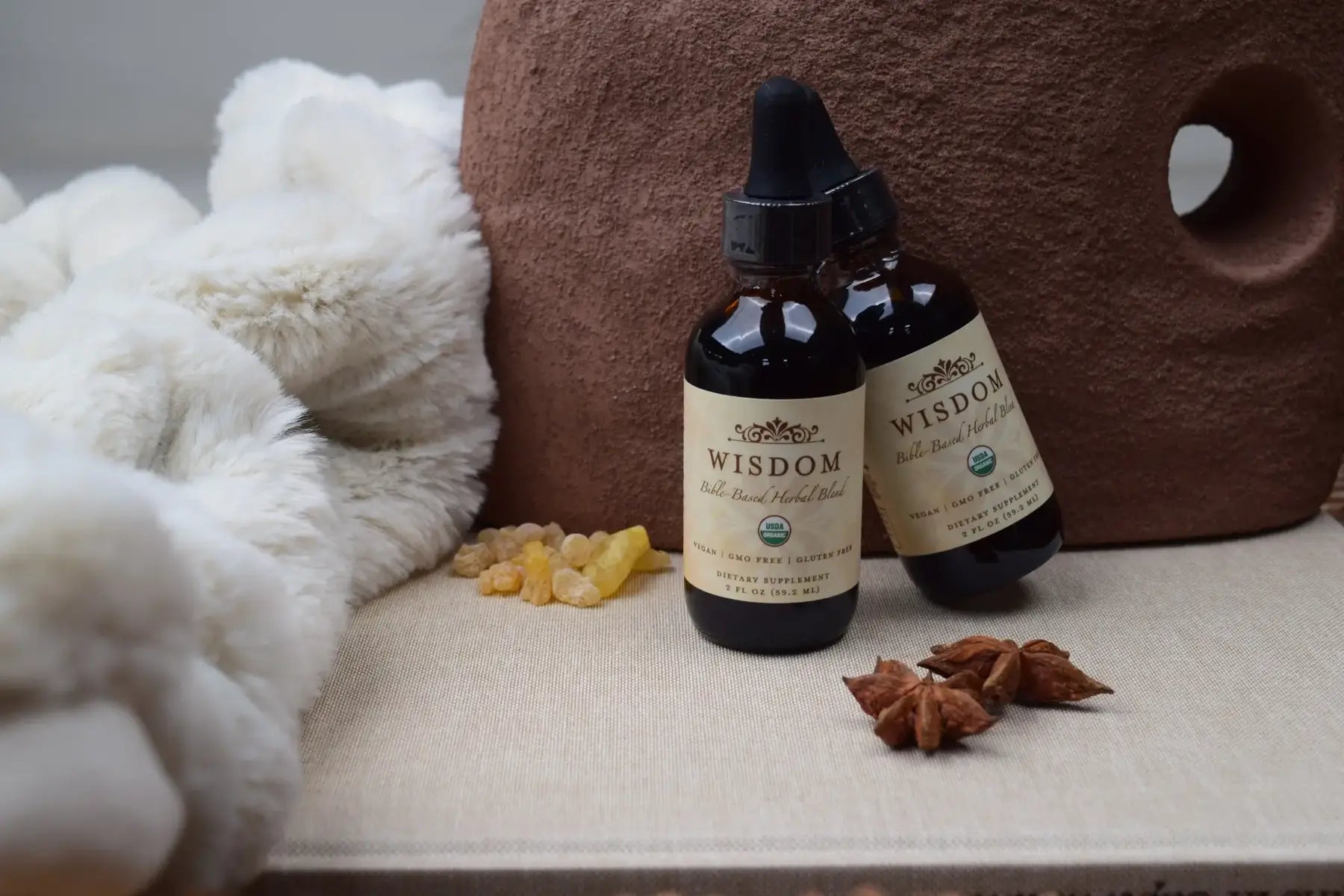 Wisdom Formula bottles styled with natural botanicals