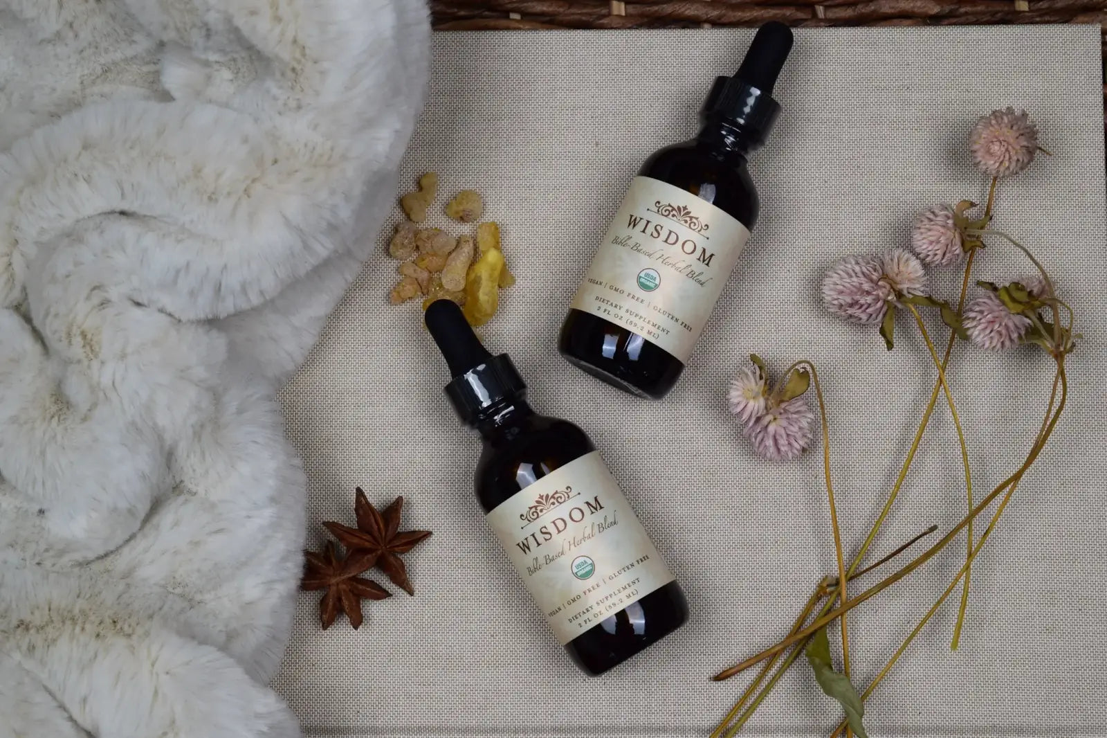 Wisdom Formula bottles and botanicals in a warm natural setting